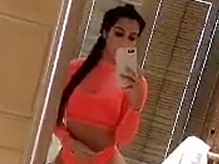 Kim Kardashian Practically Brings the Peach Emoji to Life in This Sheer Orange Swim Look