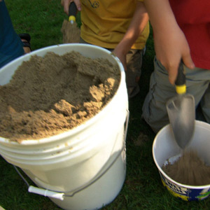 kids making imprints of fossils