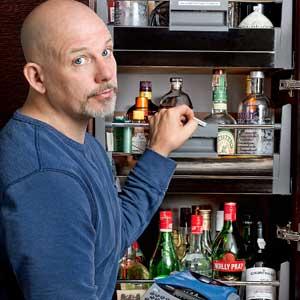 This Old House Editor Scott Omelianuk applying labels to a cluttered shelf