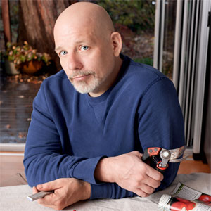 Scott Omelianuk holding pruners and sharpening stone