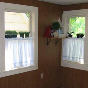 sun room with old dark wood paneling on walls