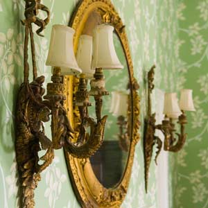 green floral paper with mirror and candlesticks