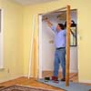 Use a claw hammer to pry the existing doorjambs from the opening