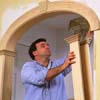 Stand the columns under the arch and slip them over the walls