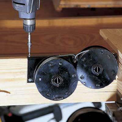 Install the spring drums for the pulley system that will allow staircase to slide down when attic door opens