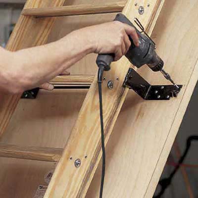 Attach stairs to door panel before enabling pulley system on attic stairs