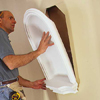placing the niche into the wall for temporary install with adhesive to hold in place while nailing in