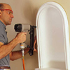 using a pneumatic nailer to nail the niche into place with minimal dings