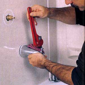 removing the tub spout with a pipe wrench