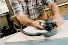 Norm Abram using a random-orbit sander