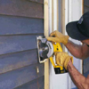 Run a circular saw along the guide, cutting only through the siding