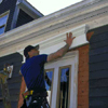 Apply a bead of urethane adhesive to the back of the pediment, press it into position above the door