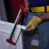 Cut the flange with a hacksaw to match the height of the door opening