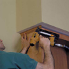 install finishing crown to top of cabinet unit