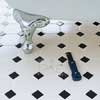remove the grout with a carbide-tipped scoring tool