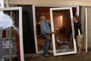 tom silva helping a homeowner install a sliding glass door