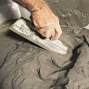 mixing cement stucco with a trowel