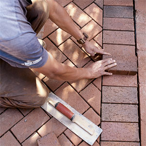 setting brick into a brick patio