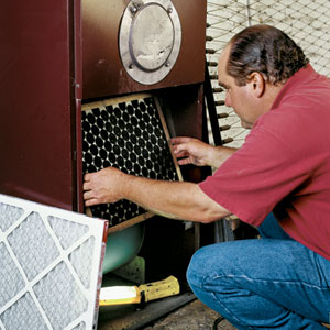 Richard Trethewey installs a media filter in a forced-air furnace