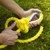 tying a secure knot to attach the rope that will hold up the swing