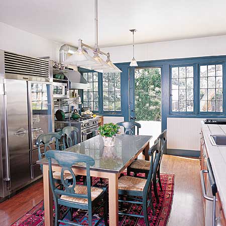 kitchen with centrally located table for eating and prep