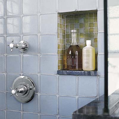 recycled glass tiles are used in teh shower and built-in niche