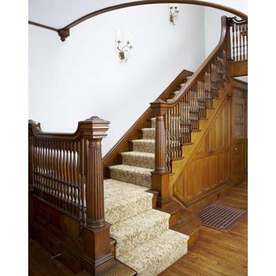 staircase with wood paneling