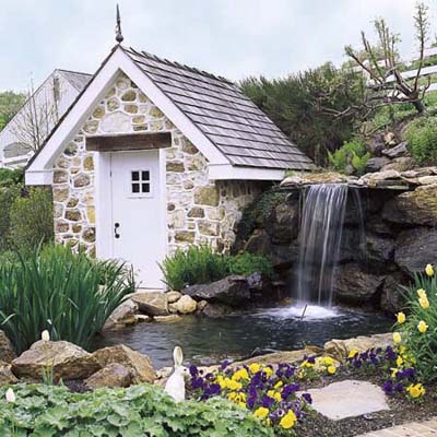 pond with waterfall and cute stone storage house
