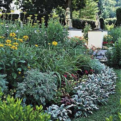 make layered plant beds by placing plants according to height, with the tallest in back, medium-height plants in the middle, and the shortest ones in front