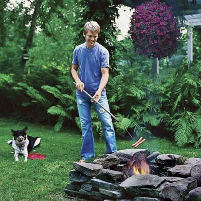 Bruce Littlefield roasting hotdogs in his fire pit