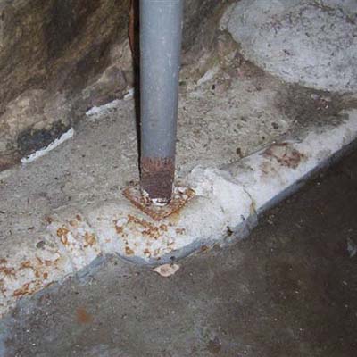 support column for main beam of house sitting on cast-iron drain pipe