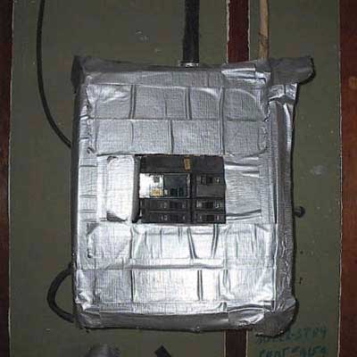 a duct tape front cover of the main electric panel at an electrician’s home