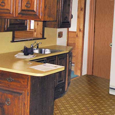 before shot of vinyl floors and dark cabinets