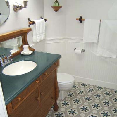carriage house bath after renovation with refurbished wood vanity and wood fixtures
