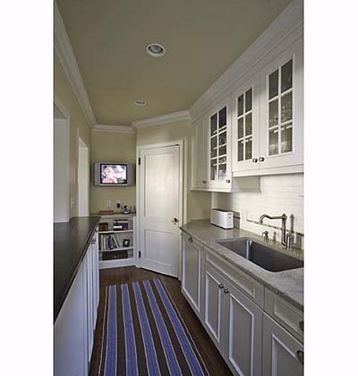 small kitchen with crown molding and flatscreen television
