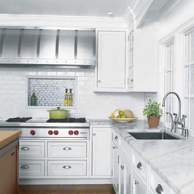 white kitchen with marble counters and steel accents