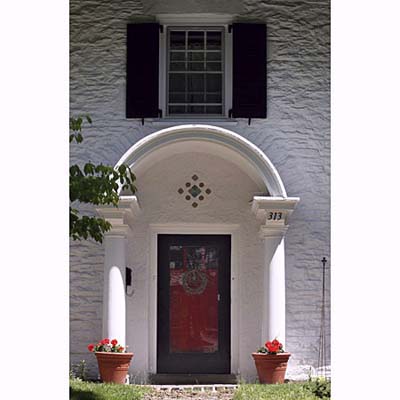 basket arch atop Roman Doric columns 