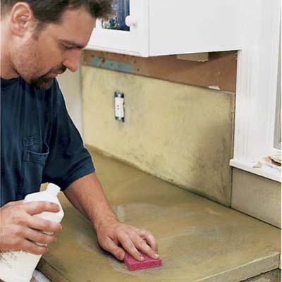 man wipes the countertop
