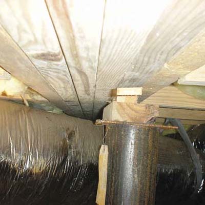shims holding up main support girder for house