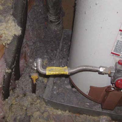 accumulation of flammable lint surrounding the base of a gas water heater