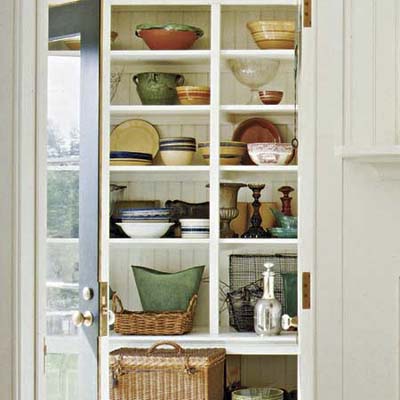 A vestibule with open shelves used for storage.