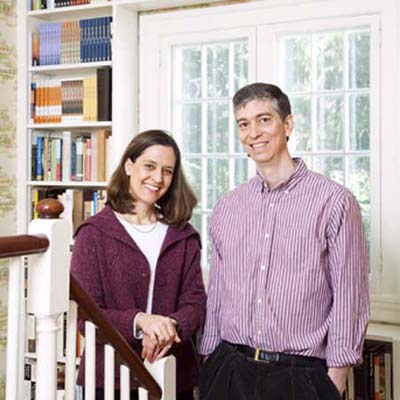 owners of the newton centre project house standing before bookshelves