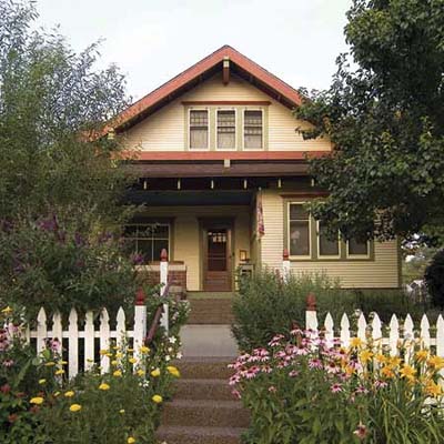 entryway with open picket fencing and perennials