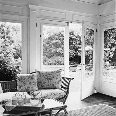 screened in porch with furniture