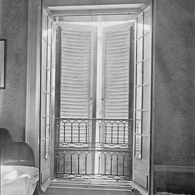 window with storm shutters open to the interior
