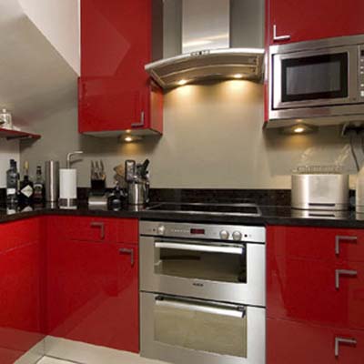 kitchen cabinets fronted by high-gloss, solid surface material doors