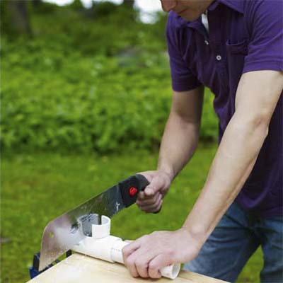 handsaw cutting pvc pipe pipe