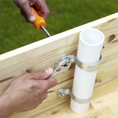 attaching the pipe strap assembly to the teeter-totter board