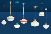 7 schoolhouse pendant lights hanging in an undefined blue room