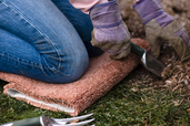 carpet scrap used as a kneeling pad in garden